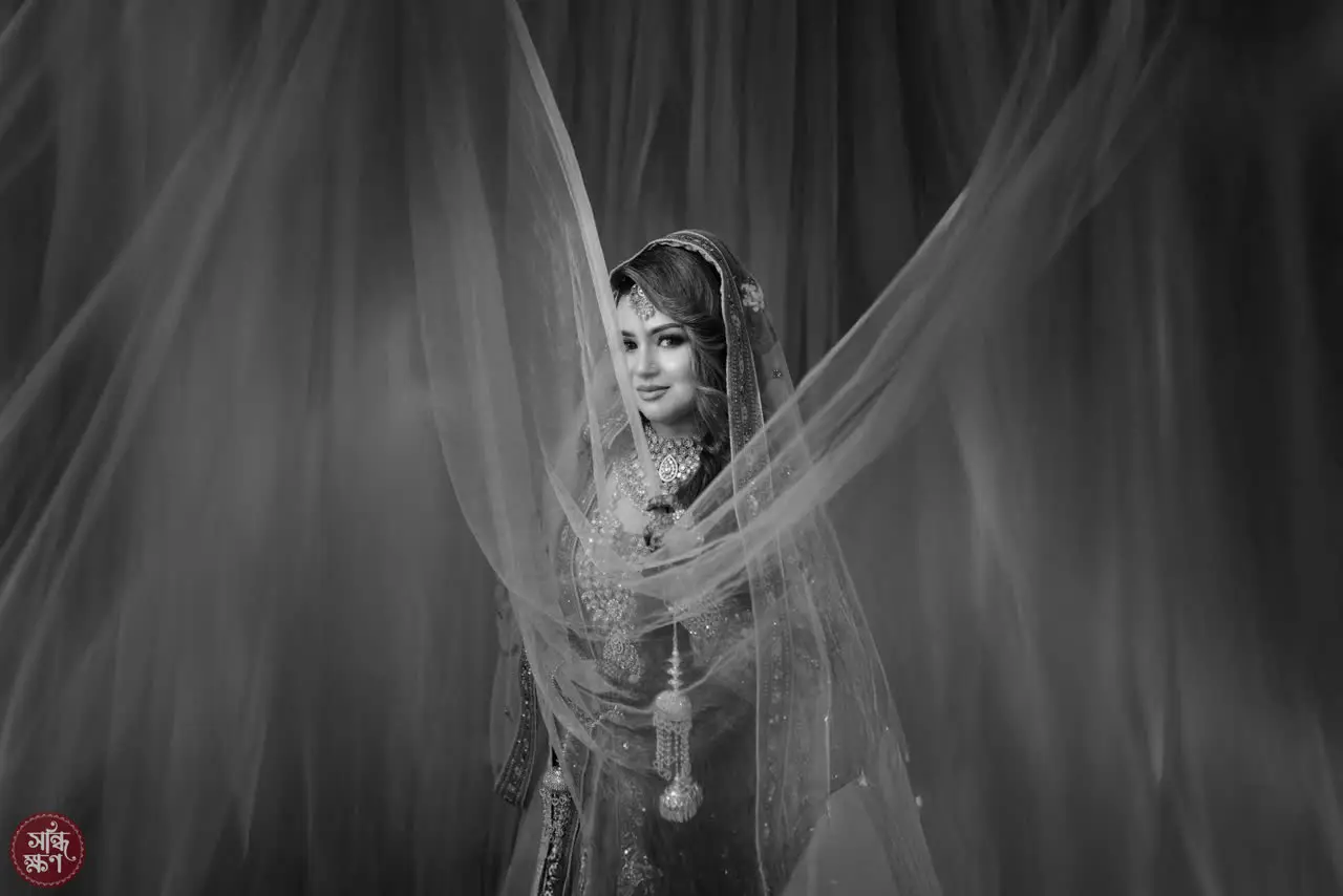 Black-and-white portrait of Nadia framed by drifting fabric
