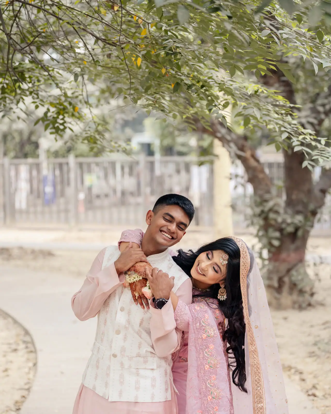 Tanvir pulls a face as Nadia laughs, both in pale pink